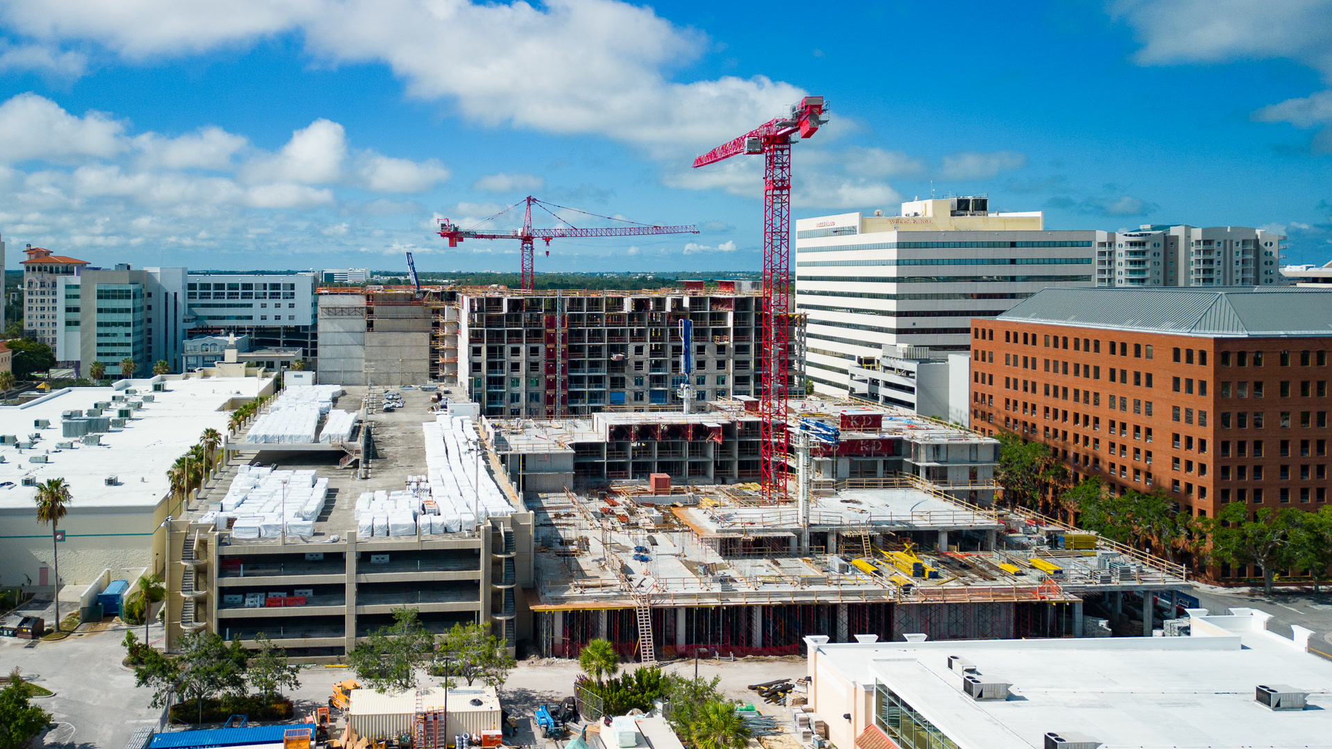 Urban construction site with red tower crane