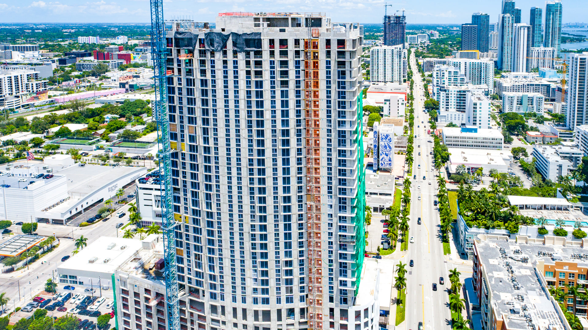 Downtown high-rise under construction with blue crane