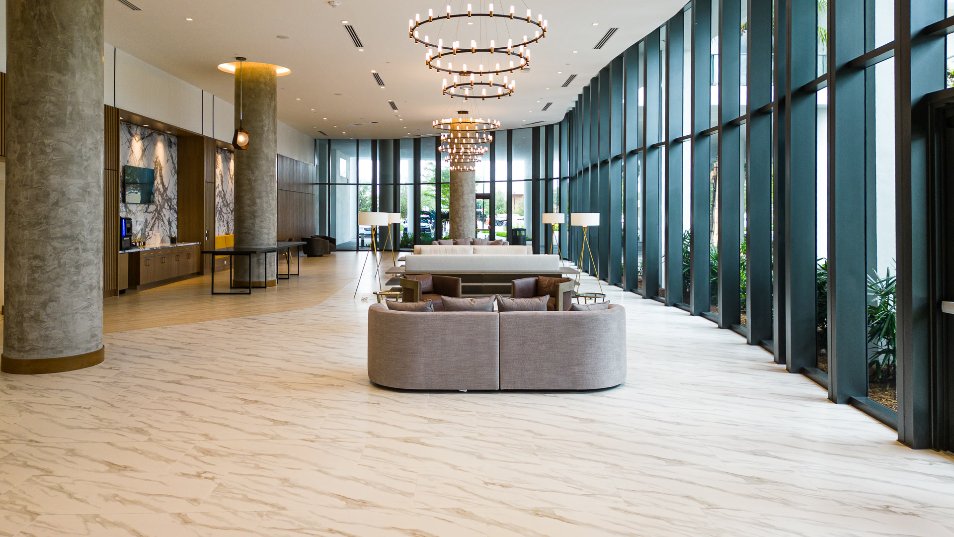 Finished modern lobby with chandeliers and marble floor