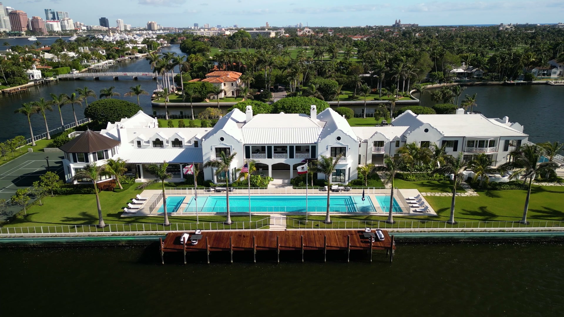 Aerial view of a waterfront Palm Beach estate with pool and dock